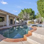 Take a dip in the pool and enjoy the backyard oasis.