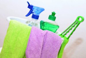 Green home cleaning tips and a bucket of supplies. 